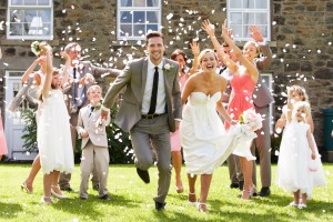 Guests Throwing Confetti Over Bride And Groom